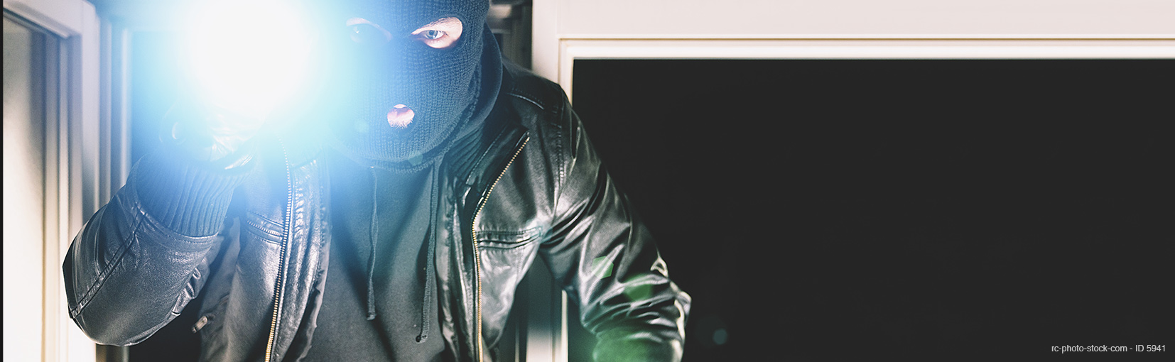 Burglar with crowbar and flashlight, with copy space, banner size from ©rcfotostock